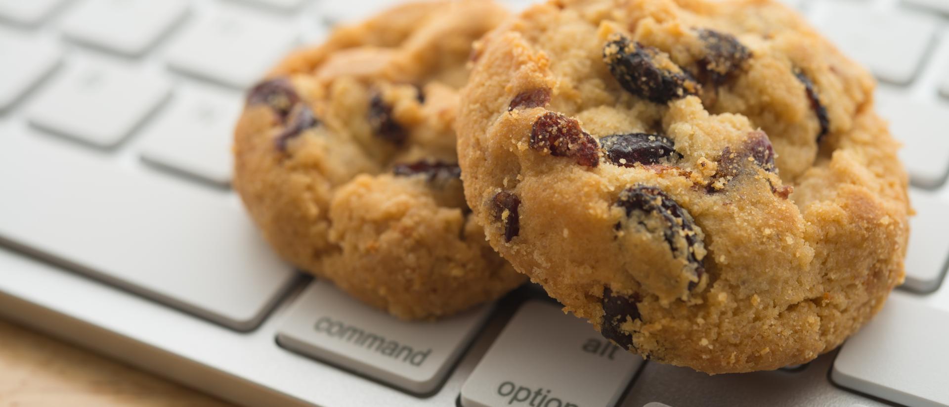 Two chocolate cookies on a keyboard
