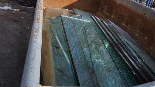 End-of-life glazing, neatly separated from frames and securely stored in a designated container