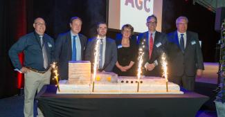 AGC and public officials in front of the cake in the form of a complete float line 