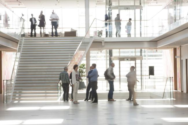 work environment in a bright building with large windows, floors and stairs