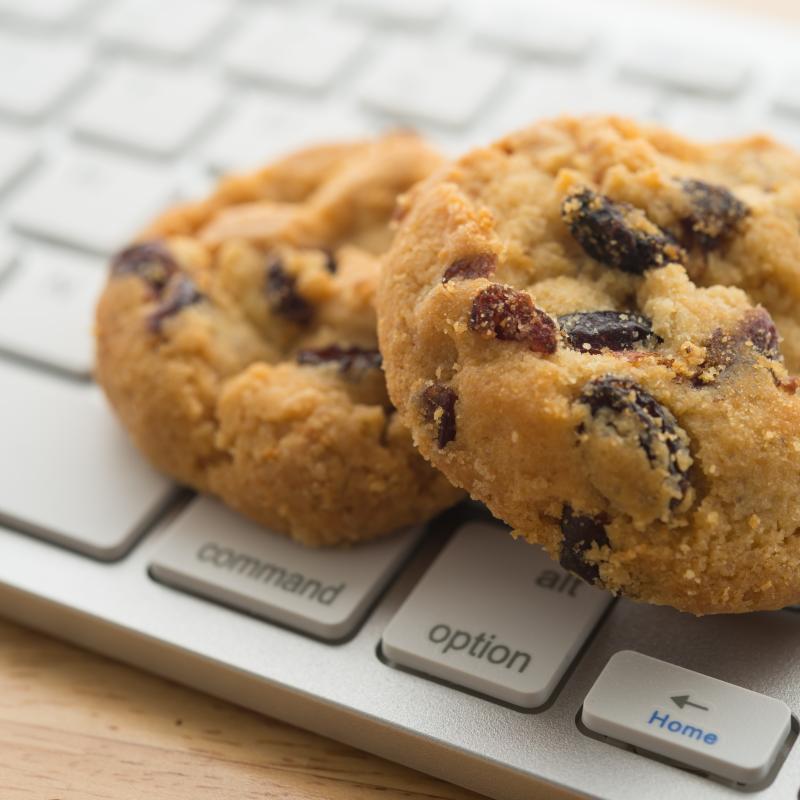 Two chocolate cookies on a keyboard